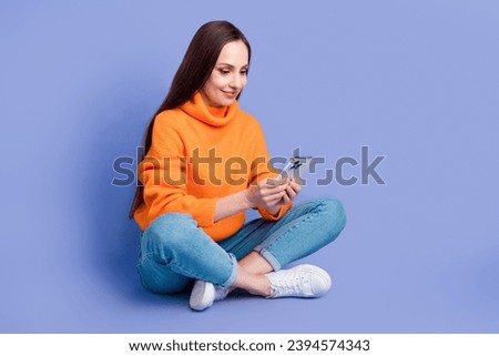 Full length size photo of progressive young lady using smartphone communicating customers in online isolated on violet color background