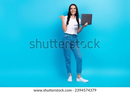 Full length photo of clever dreamy girl dressed white shirt texting modern gadget thumb empty space isolated blue color background
