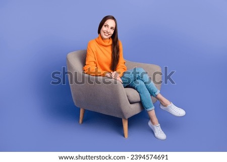 Full body photo of cheerful lady in gray armchair sitting relaxed look empty space curious discount isolated on violet color background