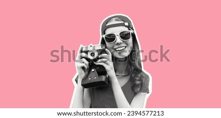 Portrait of happy cheerful smiling young woman photographer taking picture on film camera wearing baseball cap on pink studio background, magazine style