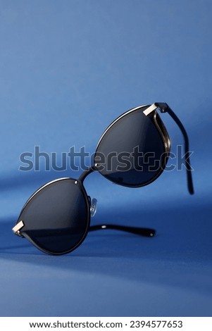 Trendy sunglasses background. Fashion summer accessories. Copy space for text. Blue concept. Optic store discount poster Royalty-Free Stock Photo #2394577653