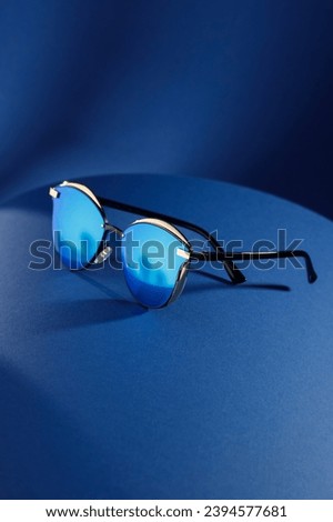 Trendy sunglasses background. Fashion summer accessories. Copy space for text. Blue concept. Optic store discount poster