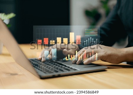 The business strategy involves using a laptop for digital marketing and making data warehouse purchases. Royalty-Free Stock Photo #2394586849