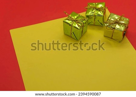 Christmas gift boxes on a yellow and red background. Copy space.