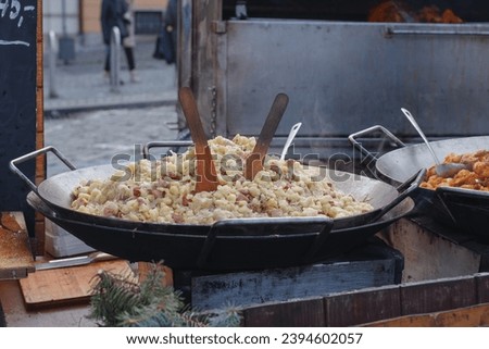 Cooking of potato dumplings with sheep cheese and bacon at Christmas market on the Cabbage Market  Brno, Czech Republic