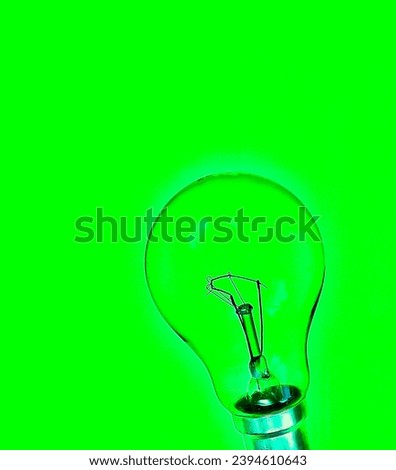 An abstract photograph of a light bulb against a green translucent background depicting Green Energy