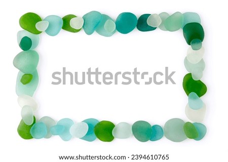 Rectangular frame laid out from blue and green glass sea pebbles and fragments of bottles polished by waves isolated on a white background.