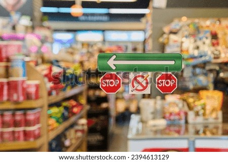Stop, no smoking signs before entering a supermarket, blurred background. Stop smoking concept
