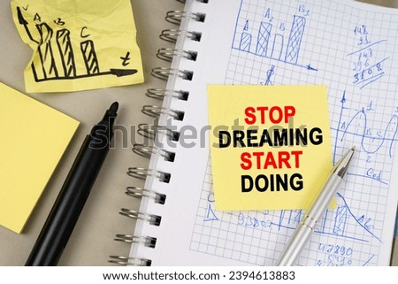 Business concept. On the table there is a notepad with notes and sticky notes with the inscription - Stop Dreaming Start Doing
