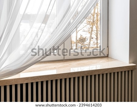 Modern window sill made of marble stone. Close-up shot Royalty-Free Stock Photo #2394614203