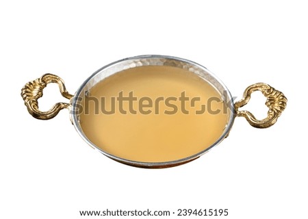 Clear broth stock without meat in cooking skillet. Isolated, white background