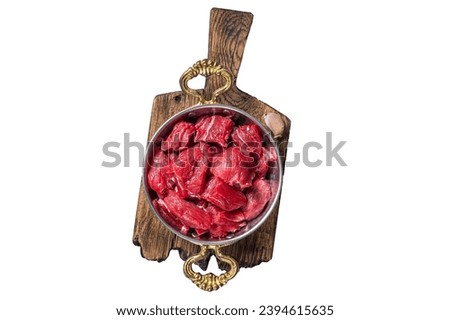Uncooked Raw diced beef veal meat for stew in skillet. Isolated, white background Royalty-Free Stock Photo #2394615635