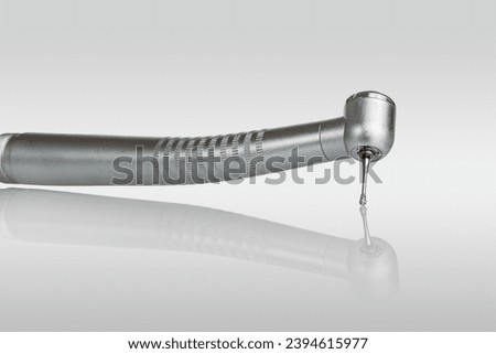dental turbine handpiece for caries treatment isolated on white background, close-up Royalty-Free Stock Photo #2394615977