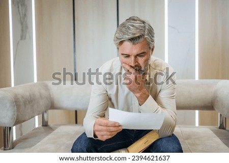 stressed businessman opening envelope reading bad news in mail letter. Mad man feels frustrated about high bills, dismissal notice, bank debt, tax invoice or mistake Royalty-Free Stock Photo #2394621637