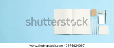 Stationery mockup with copybook on blue background, space for text
