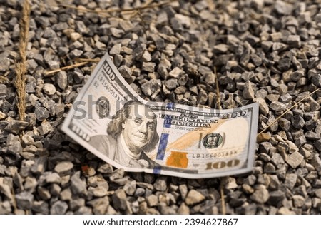 One Hundred Dollars are on the ground. Close-up Royalty-Free Stock Photo #2394627867