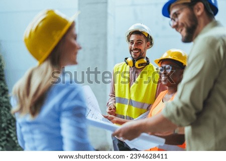 Team of construction workers discussing project details with executive supervisor. Group of architects and civil engineers inspecting construction site. Structural engineer and architect discussing.