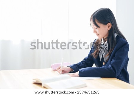 asian elementary school girl studying in classroom Royalty-Free Stock Photo #2394631263