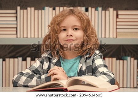 Child reading book in a book store or library,