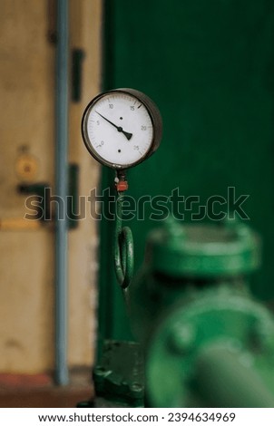 Industrial pressure gauge with a scale for measuring pressure in a pipeline. Photography, industry concept.