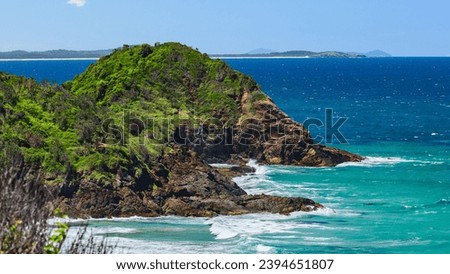 Australian coast with rocks on the seashore, view from the cliff of the seaside landscape with blue water on a summer sunny day.