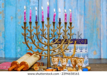 Hanukkiah menorah with burning candles is traditional religious symbol of Jewish holiday Hanukkah