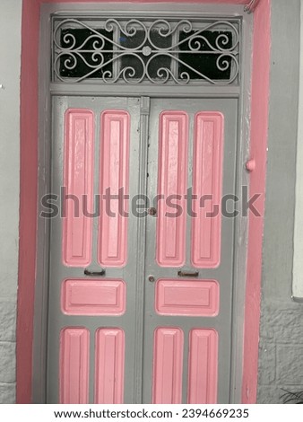 Traditional old door in pink and light grey