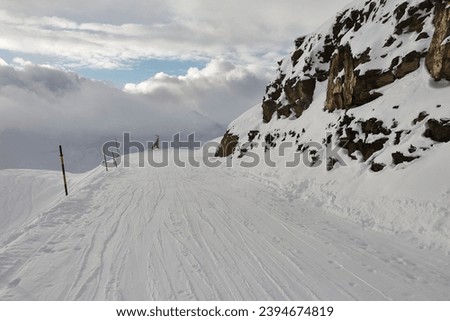 Skiing slope in the French Alpes Royalty-Free Stock Photo #2394674819