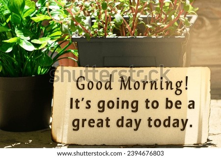 Motivational quote on brown burn paper with potted plant - Good morning It's going to be a great day today.
