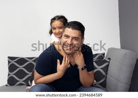 Divorced single dad and 4 year old dark latino daughter spend quality time and celebrate their day Royalty-Free Stock Photo #2394684589