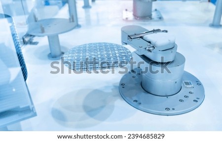 Semiconductor and Computer Chip Manufacturing at Fab or Foundry with robotic arms with silicon wafers  Royalty-Free Stock Photo #2394685829
