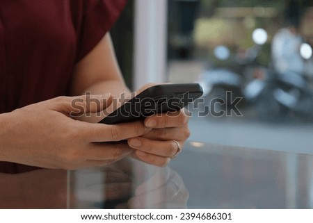 Female hand holding phone, smartphone in hand 