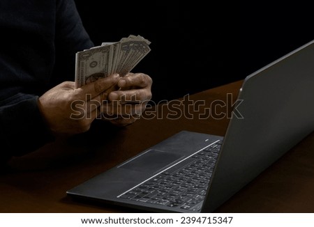 Hand hacker spy man one person in black hoodie sitting on table looking computer laptop used login password attack security to data digital internet network system night dark background copy space