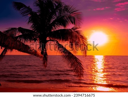 Beautiful sunset tropical beach with palm tree and pink sky for travel and vacation in holiday relax time Royalty-Free Stock Photo #2394716675