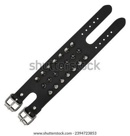 Black leather bracelet with spikes, pyramids. An accessory for rockers, bikers, metalheads, goths and punks. Steampunk style. Close-up subject photography. Royalty-Free Stock Photo #2394723853