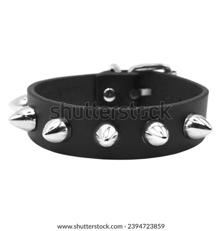 Black leather bracelet with spikes, pyramids. An accessory for rockers, bikers, metalheads, goths and punks. Steampunk style. Close-up subject photography. Royalty-Free Stock Photo #2394723859