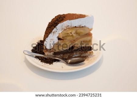 Banoffee cake with bananas and whipped cream in cafe restaurant, stock photo