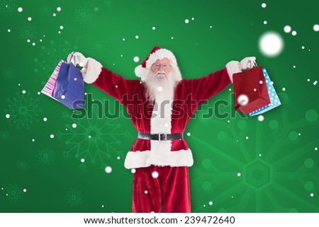 Santa holds some bags for Chistmas against green snowflake background