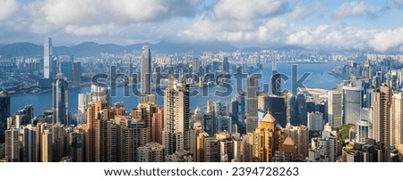 Panoramic view of Hong Kong City  in cloudy day and good weather. View of financial district high-rise and residential buildings from Victoria Peak Observation Deck 