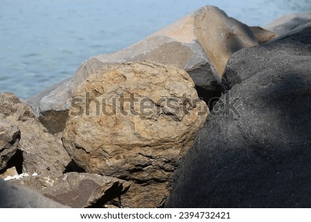 stones arranged on the beach to withstand sea waves