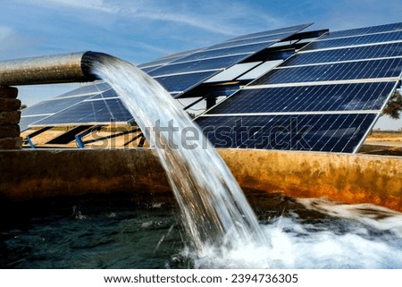 Solar panels and tube well for irrigation in the agricultural field  Royalty-Free Stock Photo #2394736305