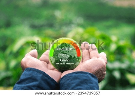 Hand protecting the earth with weather meter concept. Check good air quality and clean outside air quality. Safe from pollution, PM 2.5 dust, has a green background. Royalty-Free Stock Photo #2394739857