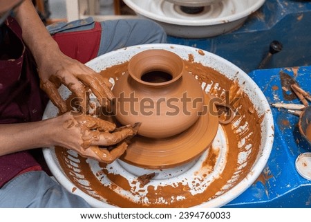 A piece of ceramic taking shape on the wheel by expert hands