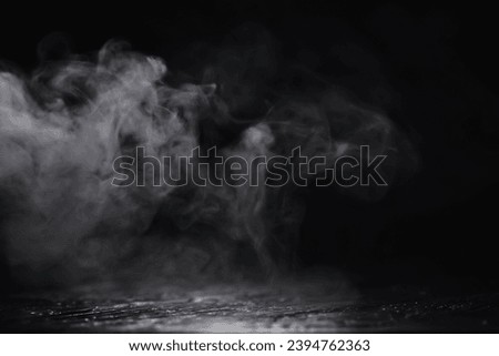 White clouds of vapor smoke are isolated on a black background. Gas explodes, swirl and dances in space. A magic fog dust texture effect that can be used by overlay and changing their transparency. Royalty-Free Stock Photo #2394762363