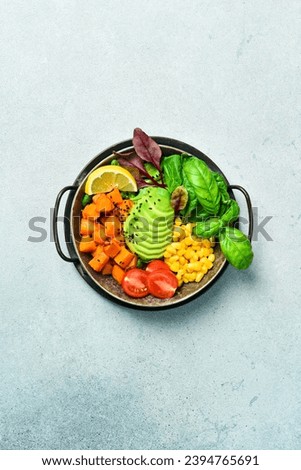 Buddha bowl: from pumpkin, avocado, corn and tomatoes, clean eating, vegan food concept. Top view