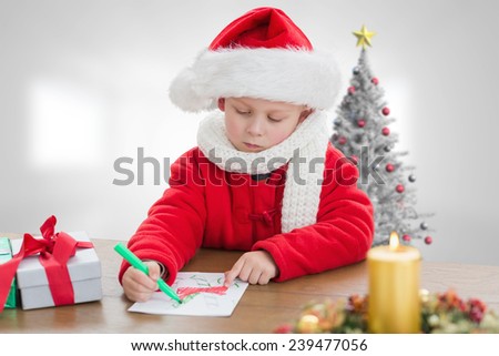 Cute boy drawing festive pictures against christmas tree in bright room