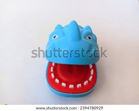 Children's toy, blue rhino-shaped toy car on an isolated background.