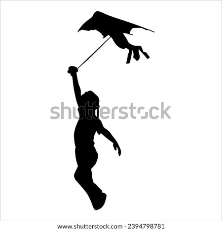 Silhouette of a child playing with a kite