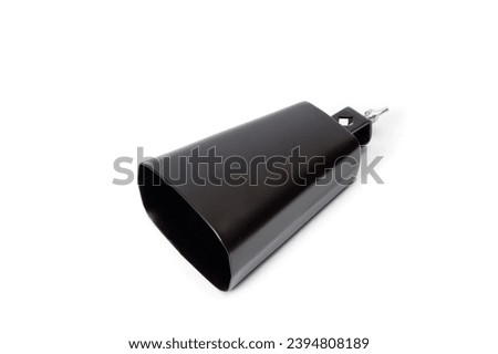 Cowbell percussion musical instrument, black metal with a wooden stick. Royalty-Free Stock Photo #2394808189