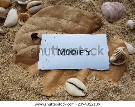 The text modify on the beach sand background.